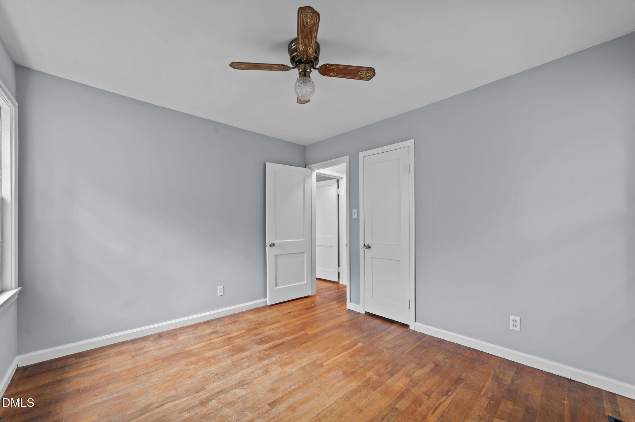 1220 Tarboro Street Rocky Mount, NC 27801 - Photo 37 of 47 a view of room with a ceiling fan and wooden floor