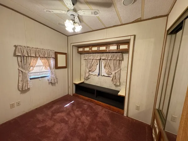a view of livingroom with hardwood floor and a ceiling fan