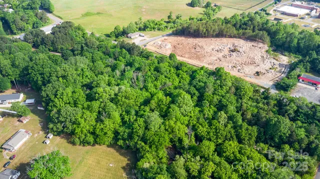 an aerial view of a house with a yard and street view