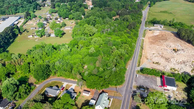 an aerial view of a house with a yard and garden