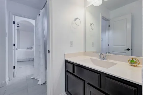 a en suite bathroom with a sink and a mirror