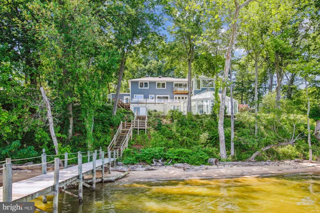 a view of a balcony with wooden floor and lake view