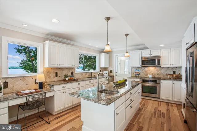 a living room with furniture a fireplace and a large window