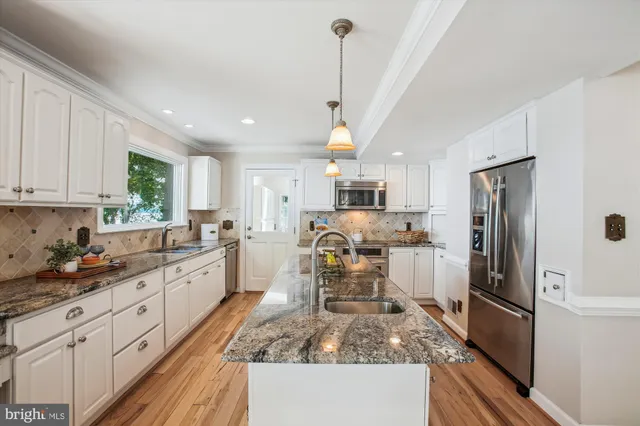 a living room with furniture a large window and a fireplace