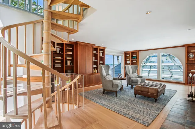 a spacious bedroom with a bed a couch and large window