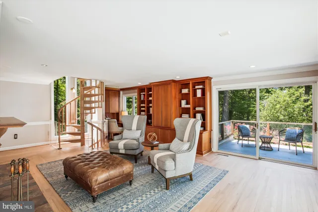 a living room with furniture a fireplace and next to a window