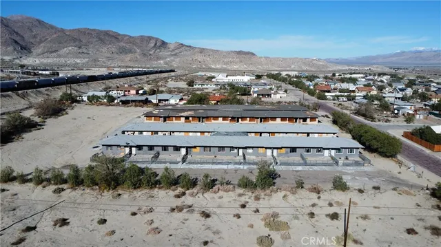 an aerial view of residential houses with outdoor space