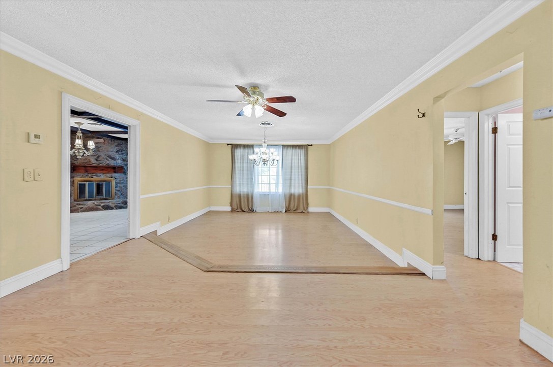 3618 Fieldcrest Road Las Vegas, NV 89121 - Photo 32 of 36 A grand, naturally illuminated dining area flows seamlessly into a cozy living space, perfect for entertaining.