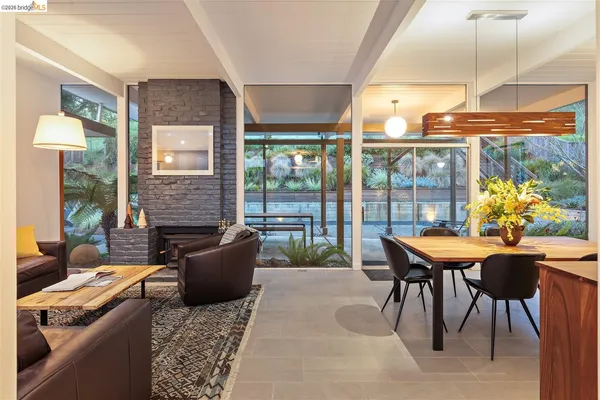 a hallway with a dining table wooden floor and a rug