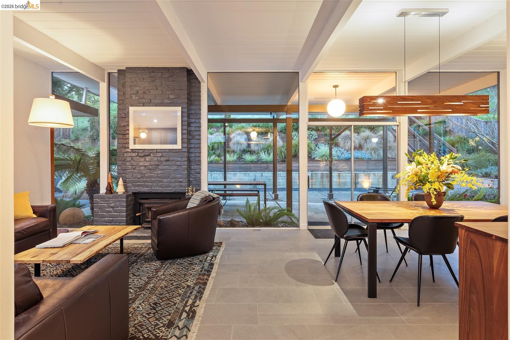 841 Montecillo Road San Rafael, CA 94903 - Photo 11 of 49 a living room with furniture a fireplace and a floor to ceiling window