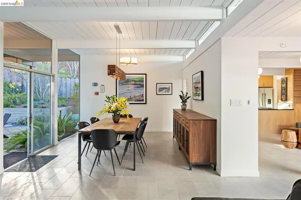 a view of a dining room with furniture window and outside view