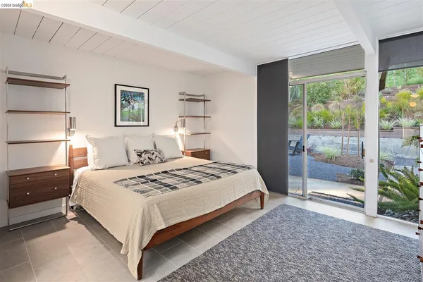 a bedroom with a bed and a night stand