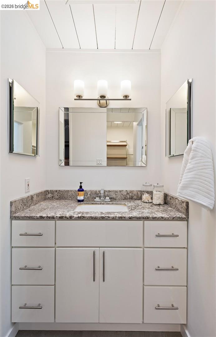 841 Montecillo Road San Rafael, CA 94903 - Photo 23 of 49 a bathroom with a granite countertop double vanity sink and mirror