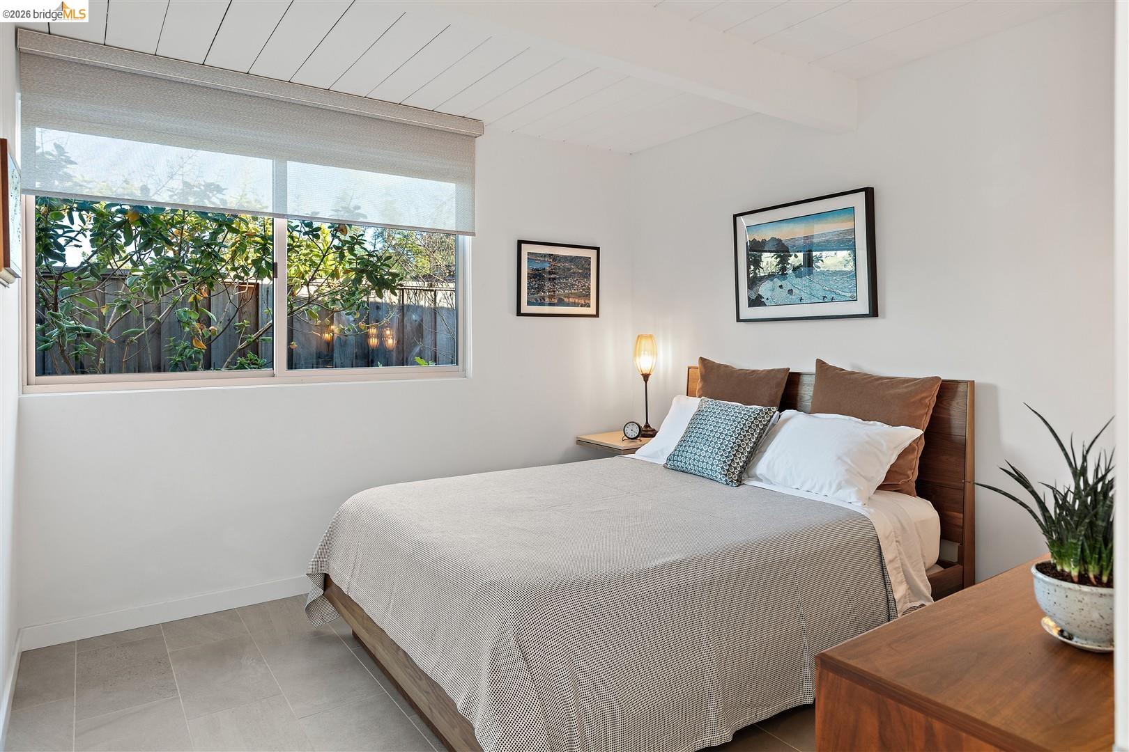 841 Montecillo Road San Rafael, CA 94903 - Photo 27 of 49 a bedroom with a large bed and a potted plant