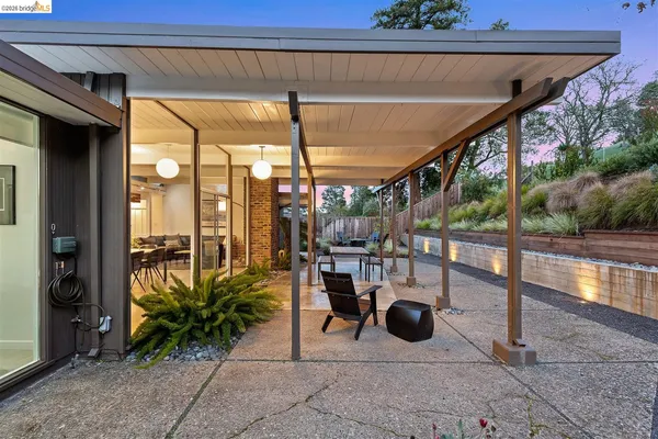 a view of a porch with furniture and a backyard