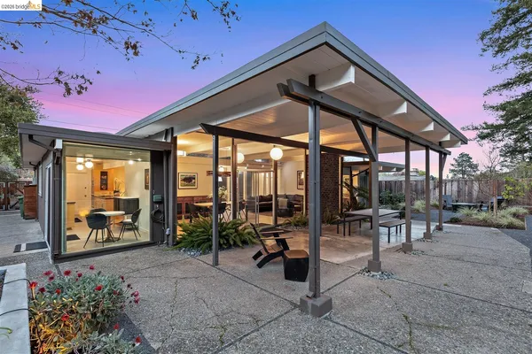 a view of a patio with table and chairs potted plants with wooden floor