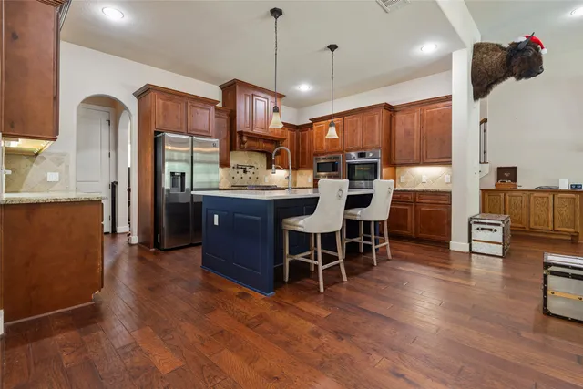 a view of kitchen with sink and wooden floor