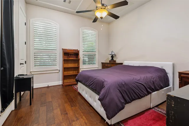 a spacious bedroom with a bed and a chandelier