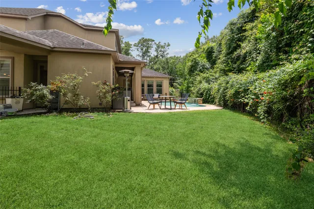 a view of a house with a yard and sitting area