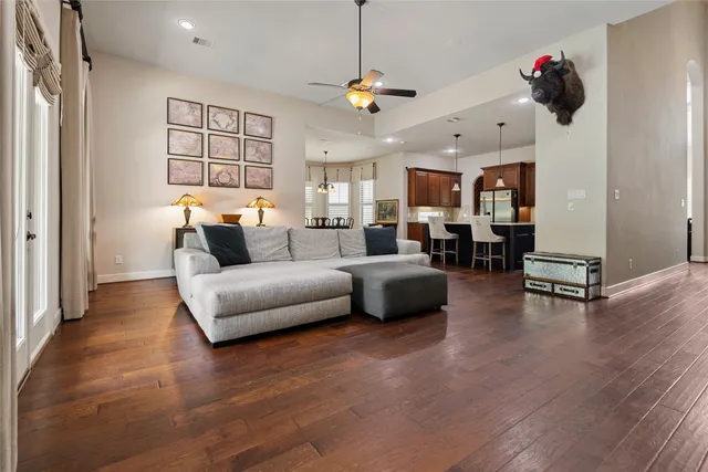 a living room with furniture and a chandelier
