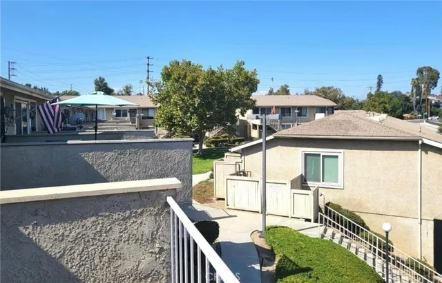 a view of a house with wooden deck and furniture