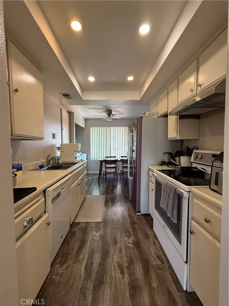 626 Bridgeport Circle, Unit 6 Fullerton, CA 92833 - Photo 4 of 6 a kitchen with stainless steel appliances granite countertop a stove a sink and a refrigerator