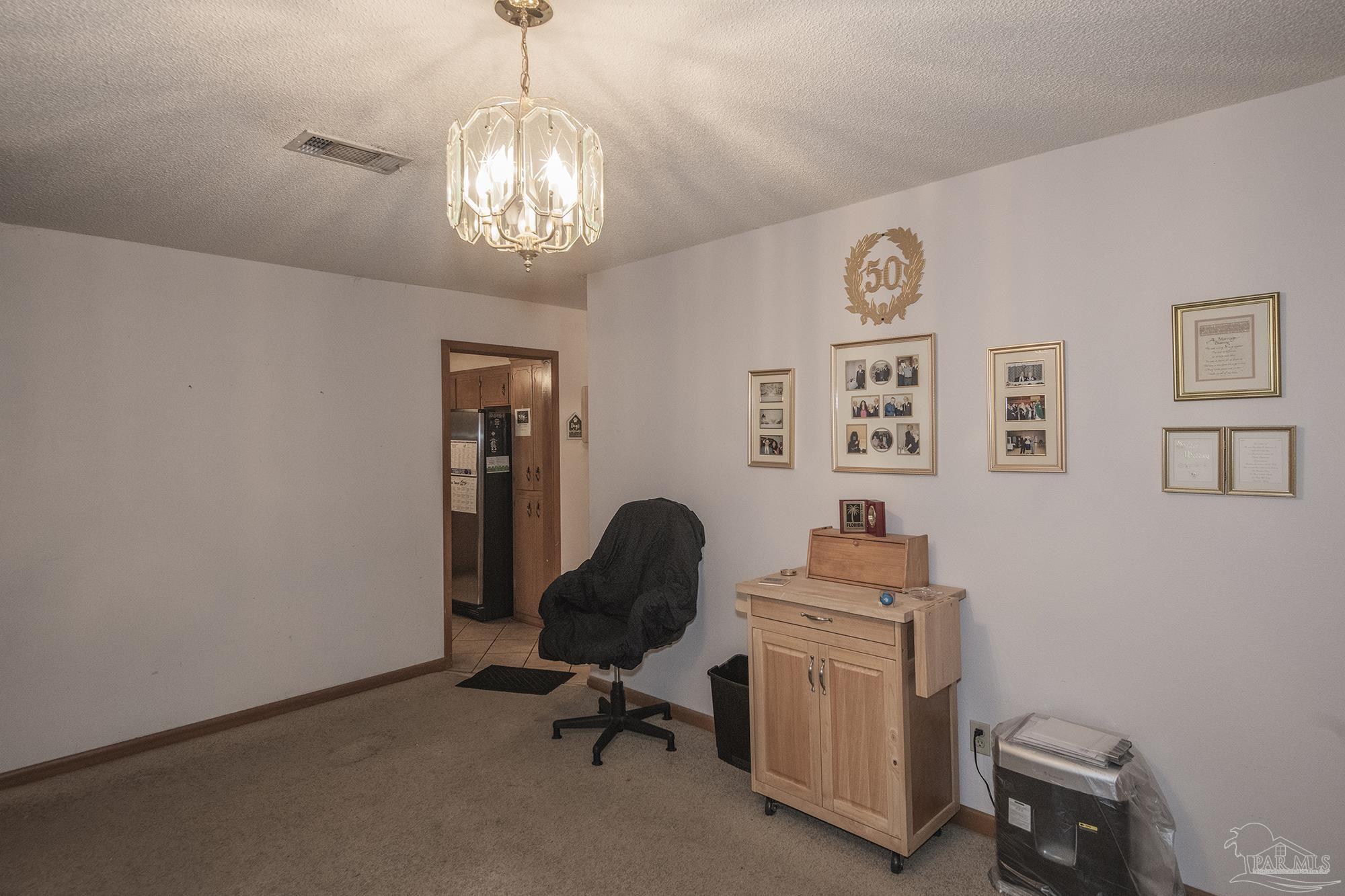 1210 Goldenrod Road Cantonment, FL 32533 - Photo 6 of 50 a view of a workspace with furniture and a window