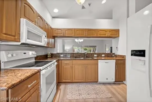 a kitchen with stainless steel appliances granite countertop a sink and cabinets