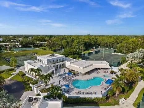 an aerial view of a house with a garden and lake view