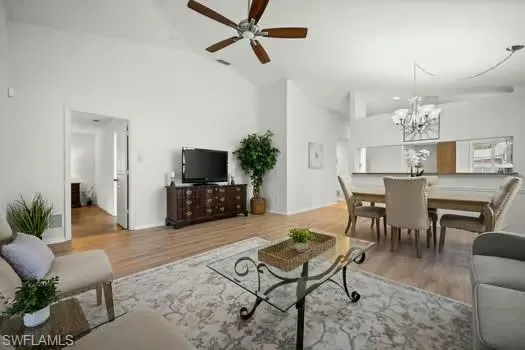 a living room with furniture a flat screen tv and a dining table