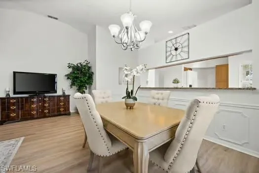 a dining room with furniture and a chandelier
