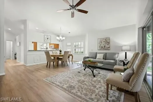 a living room with furniture and a dining table with kitchen view
