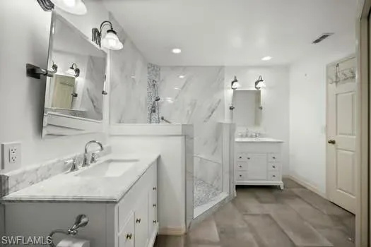 a spacious bathroom with a double vanity sink a mirror and shower