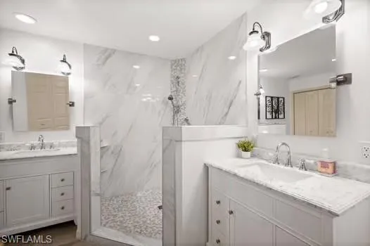 a bathroom with a granite countertop sink a mirror a vanity and shower