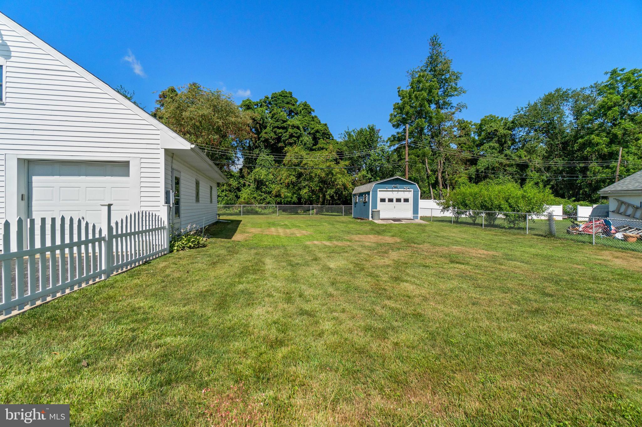 22 Peach Road Elkton, MD 21921 - Photo 24 of 24 a view of a white house with a big yard and large trees