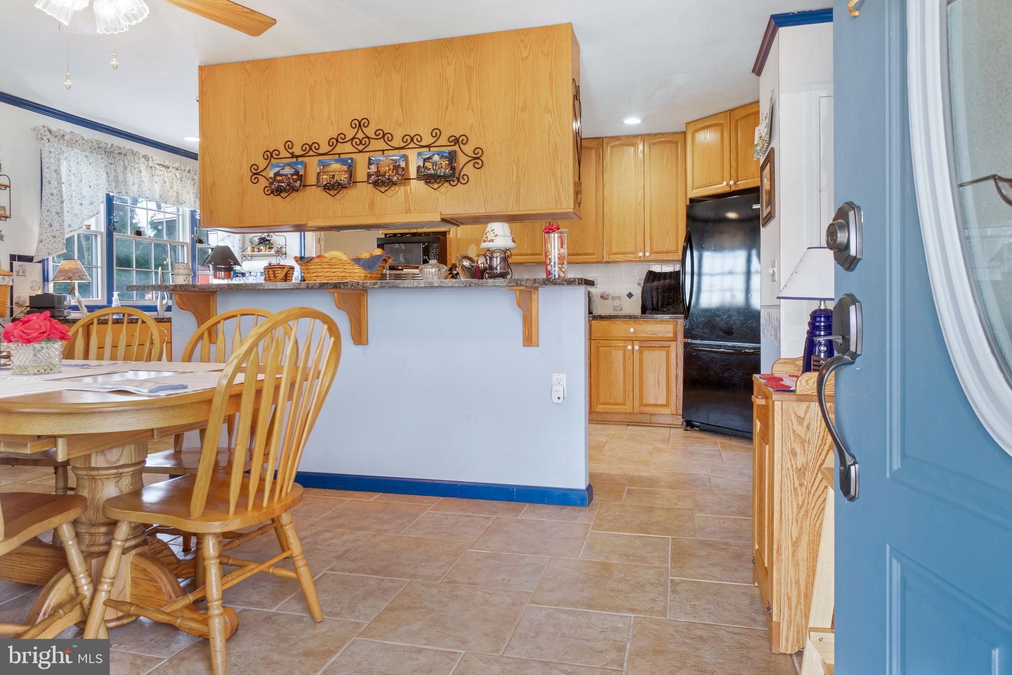 22 Peach Road Elkton, MD 21921 - Photo 6 of 24 a kitchen with stainless steel appliances kitchen island granite countertop a table and chairs in it