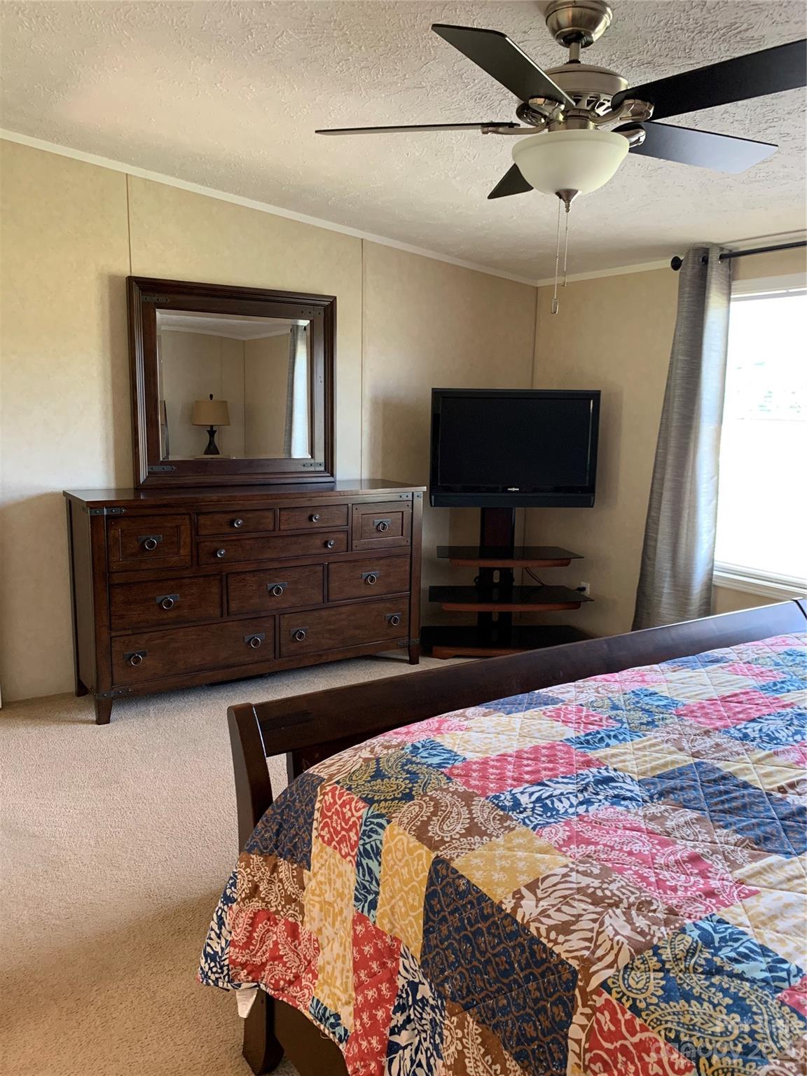 2380 Briggs Road Salisbury, NC 28147 - Photo 8 of 27 a bedroom with a bed and a flat screen tv