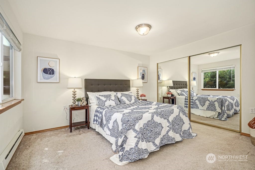 1009 112th Street Southeast, Unit E104 Everett, WA 98208 - Photo 11 of 24 a bedroom with a bed and lamp