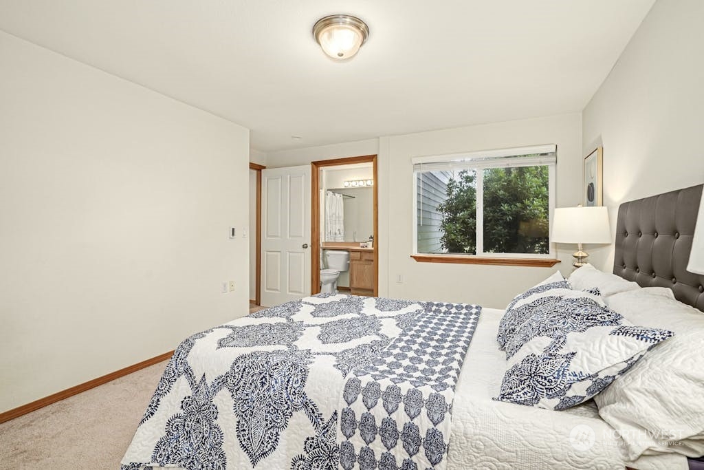 1009 112th Street Southeast, Unit E104 Everett, WA 98208 - Photo 12 of 24 a bedroom with a bed and a large window