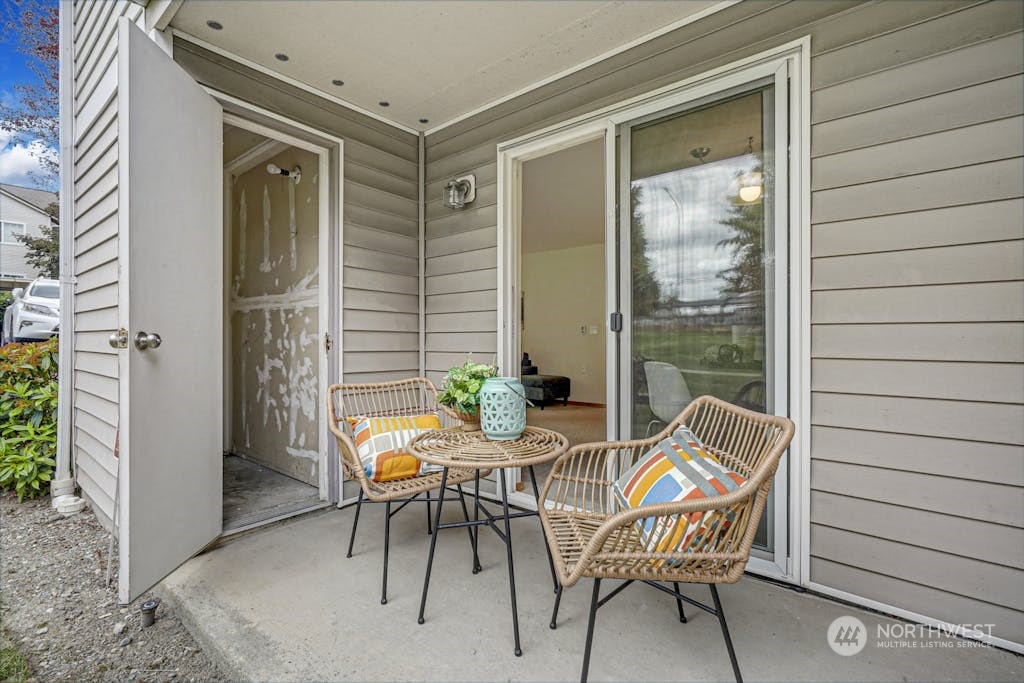 1009 112th Street Southeast, Unit E104 Everett, WA 98208 - Photo 18 of 24 a patio with table and chairs