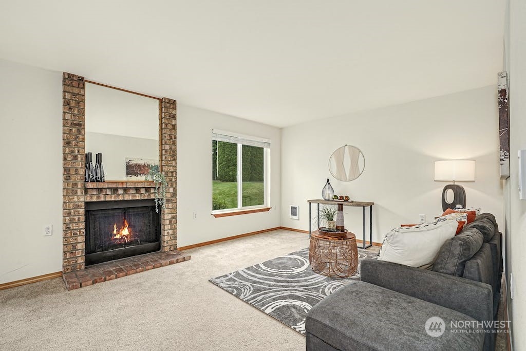 1009 112th Street Southeast, Unit E104 Everett, WA 98208 - Photo 4 of 24 a living room with furniture a window and a fireplace