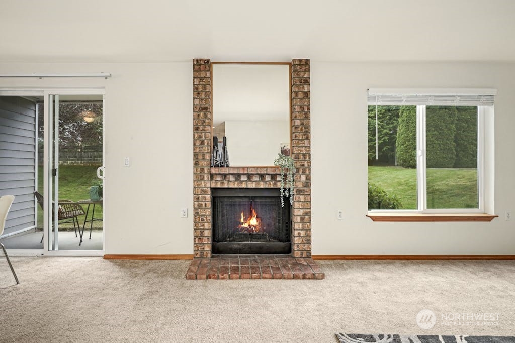 1009 112th Street Southeast, Unit E104 Everett, WA 98208 - Photo 5 of 24 a view of an empty room with a fireplace and window