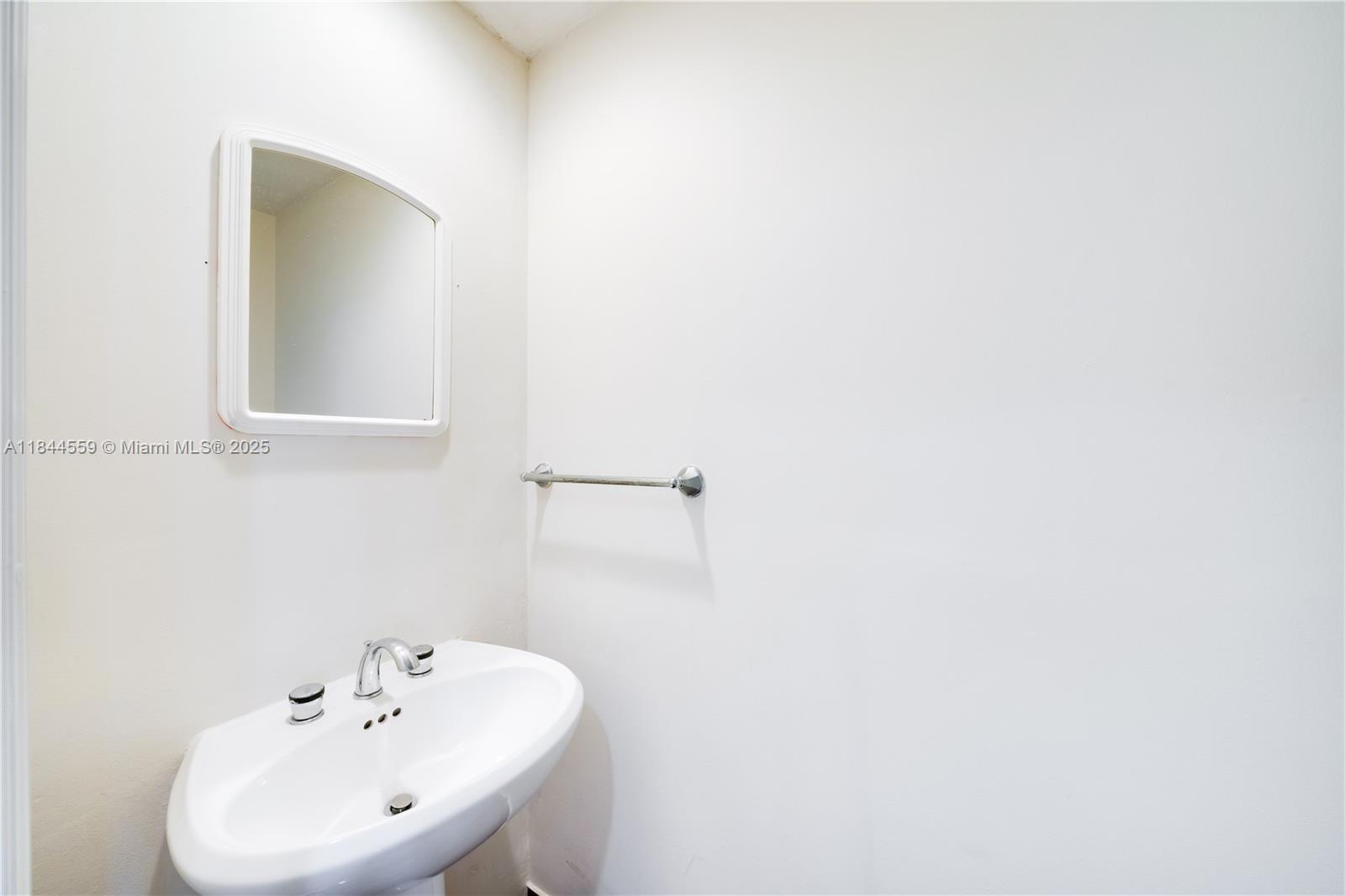 888 Brickell Key Drive, Unit 1912 Miami, FL 33131 - Photo 26 of 37 a bathroom with a sink and a mirror
