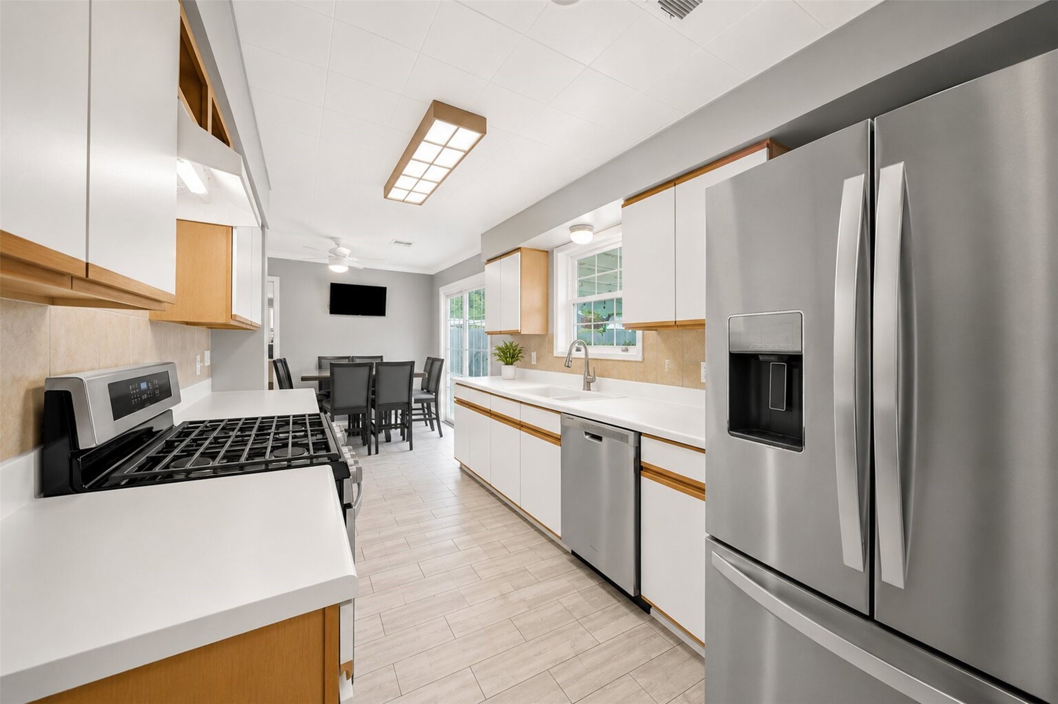 1306 Camden Road Pasadena, TX 77502 - Photo 7 of 16 Well equipped kitchen open to the dining area, featuring stainless steel appliances including a gas range and French door refrigerator perfect for cooking and entertaining!