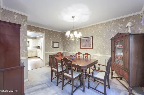 a dining room with furniture and chandelier