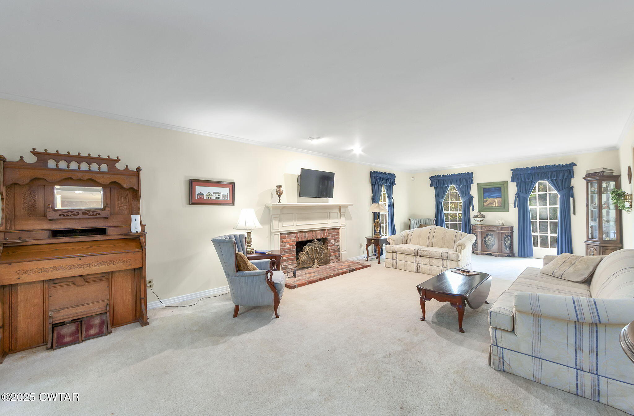 189 Valley Oak Loop Jackson, TN 38305 - Photo 8 of 22 a living room with furniture a fireplace and a flat screen tv