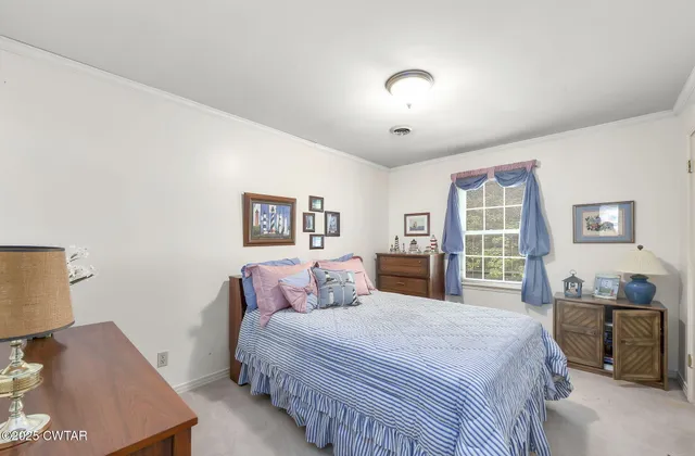 a bedroom with a large bed and a window