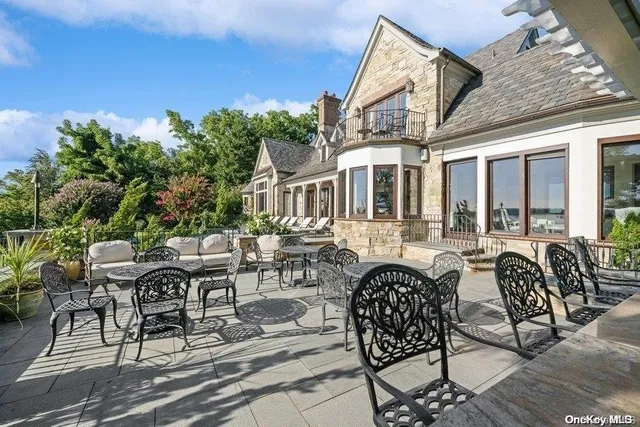 a view of a patio with couches table and chairs and potted plants