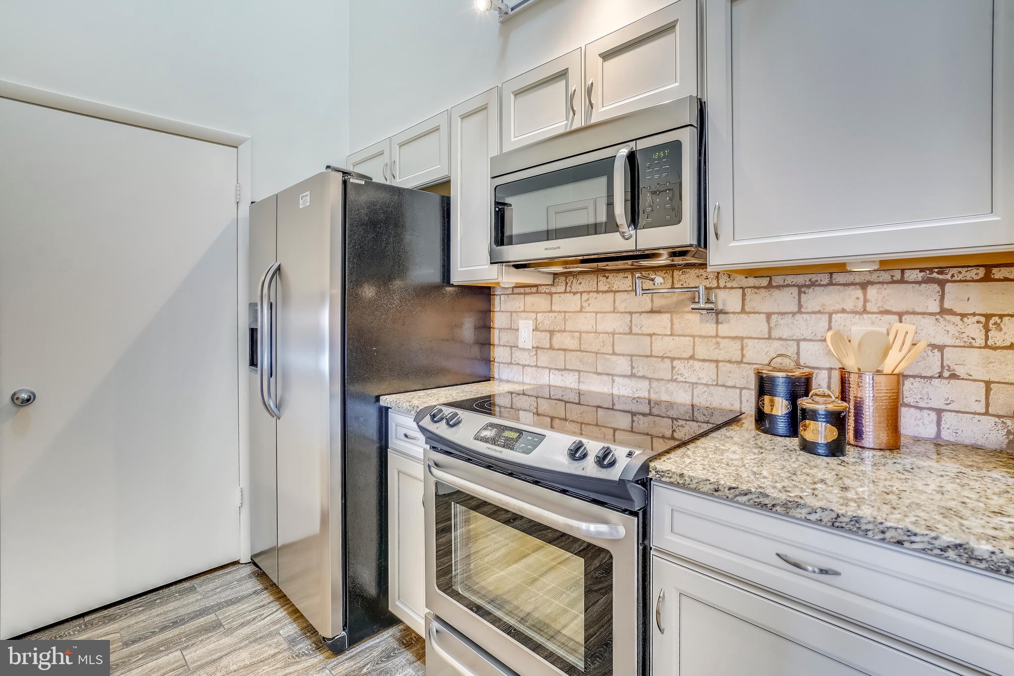 Updated kitchen leading to pantry/washer/dryer.