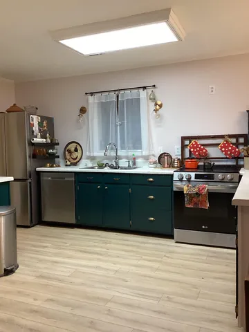 a kitchen with stainless steel appliances granite countertop a sink and a stove